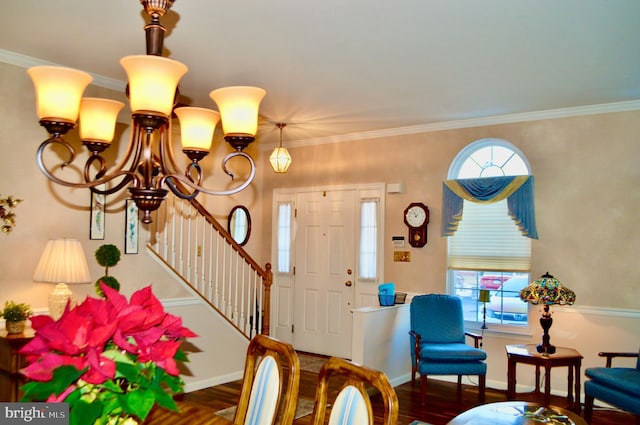 foyer entrance with crown molding, a chandelier, and dark hardwood / wood-style floors