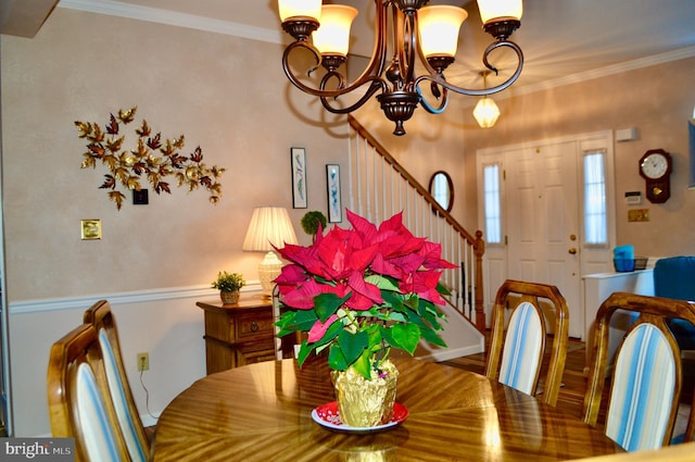 dining area with crown molding and an inviting chandelier