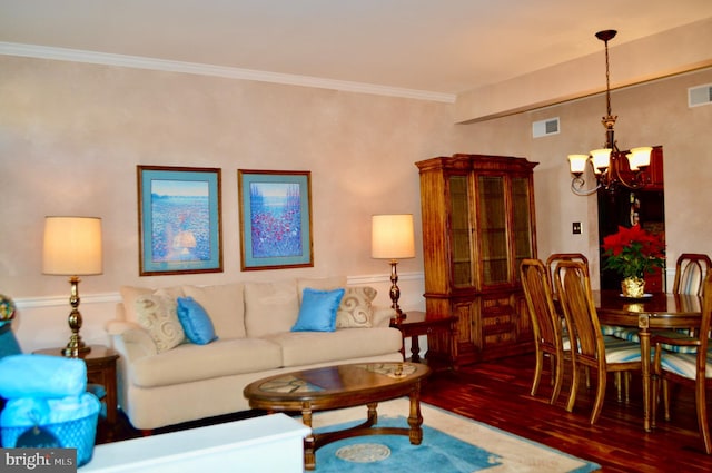 living room featuring ornamental molding, dark hardwood / wood-style floors, and a notable chandelier