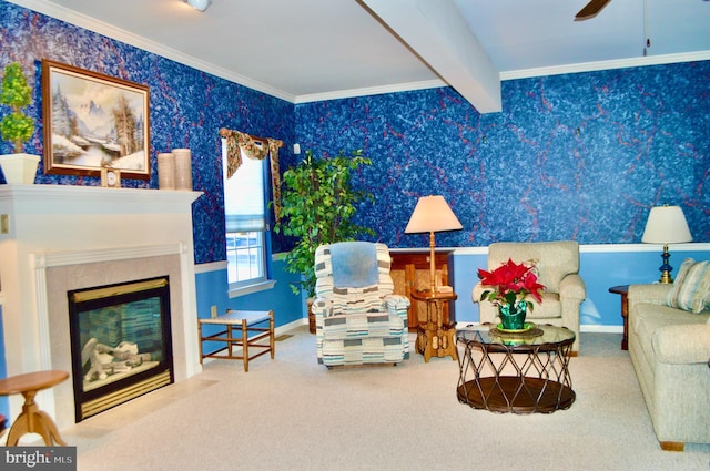 living area featuring carpet, ceiling fan, crown molding, a tile fireplace, and beam ceiling