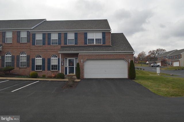 view of front of home with a front yard and a garage