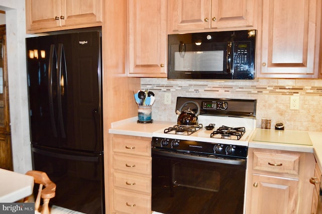 kitchen with decorative backsplash, light brown cabinetry, and black appliances