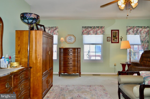 sitting room featuring light carpet and ceiling fan