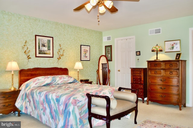 bedroom with ceiling fan and light carpet