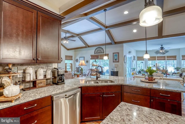 kitchen with sink, dishwasher, plenty of natural light, light stone countertops, and decorative light fixtures