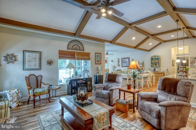 living room with vaulted ceiling with beams, hardwood / wood-style flooring, and ceiling fan