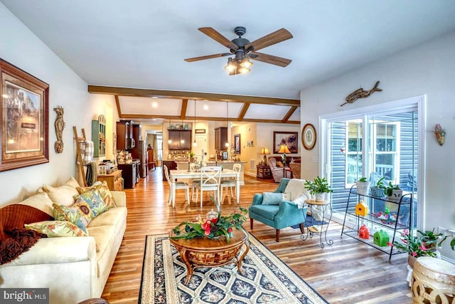 living room with beamed ceiling, hardwood / wood-style floors, and ceiling fan