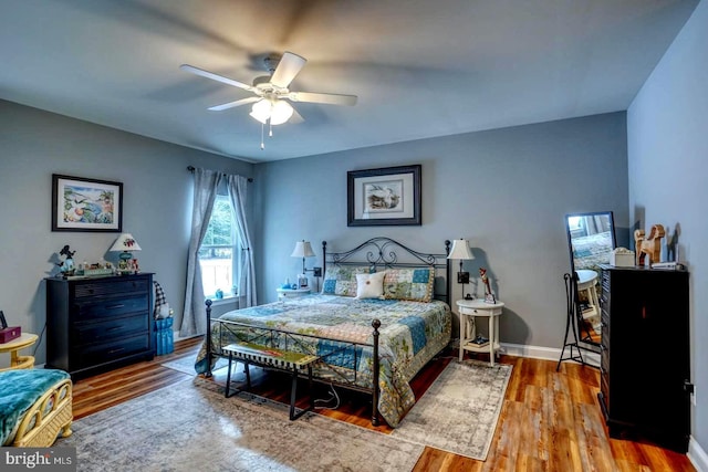 bedroom with wood-type flooring and ceiling fan