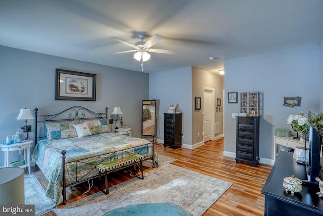 bedroom with ceiling fan and light hardwood / wood-style flooring