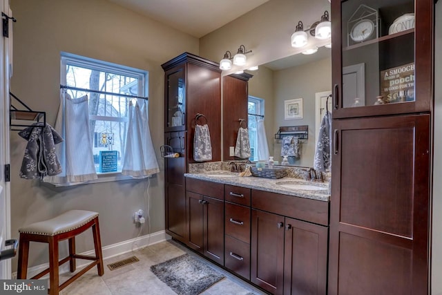 bathroom with vanity, plenty of natural light, and tile patterned floors