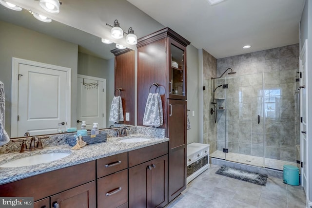 bathroom featuring vanity, tile patterned floors, and walk in shower