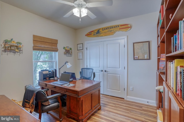 home office featuring ceiling fan and light hardwood / wood-style flooring