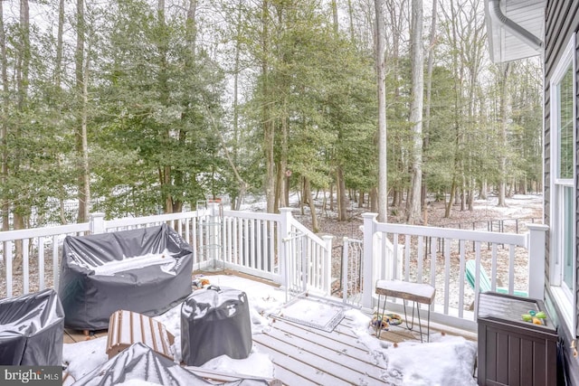 snow covered deck featuring a grill