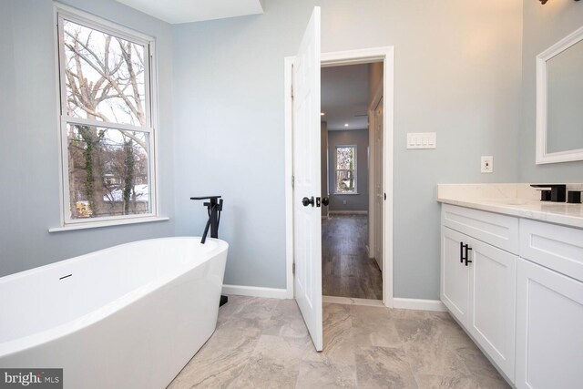 bathroom featuring a bathing tub and vanity