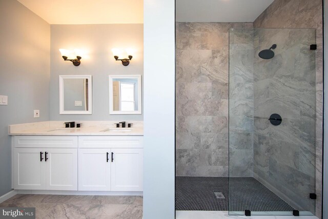 bathroom with vanity and tiled shower