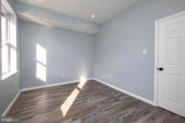 spare room with dark hardwood / wood-style flooring