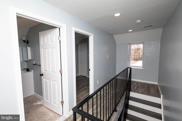 hallway with lofted ceiling