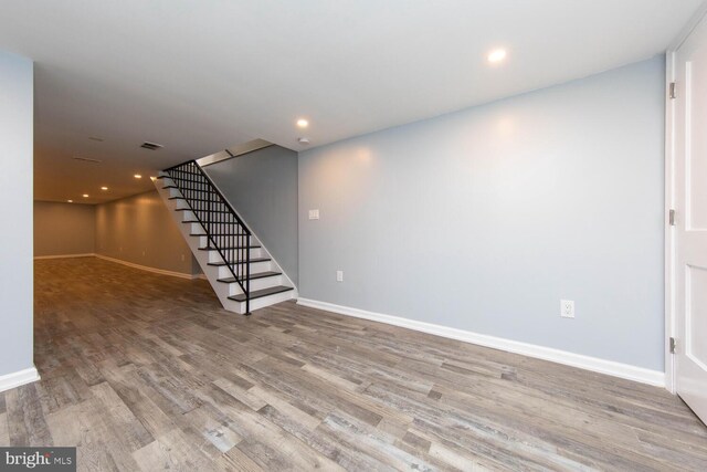 basement with hardwood / wood-style flooring