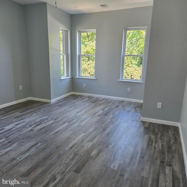 unfurnished room featuring dark wood-type flooring