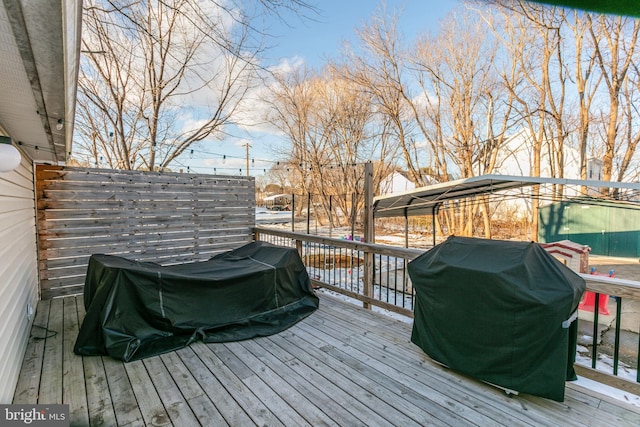 wooden deck with a grill