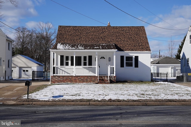 bungalow-style house with a porch, a garage, and an outdoor structure