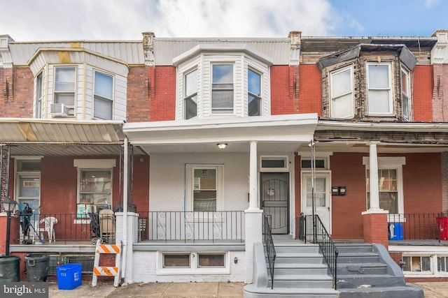 townhome / multi-family property with a porch