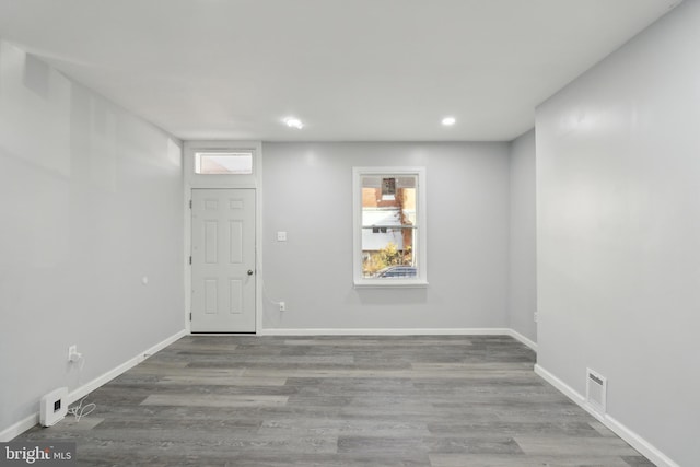 unfurnished room with wood-type flooring