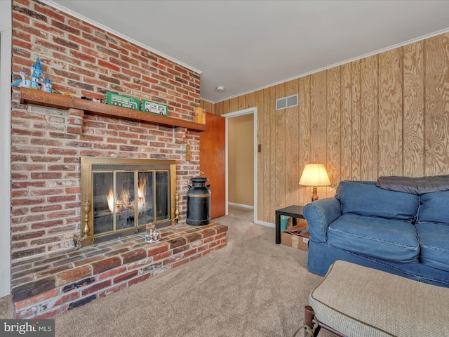 living room featuring carpet flooring, ornamental molding, a fireplace, and wooden walls