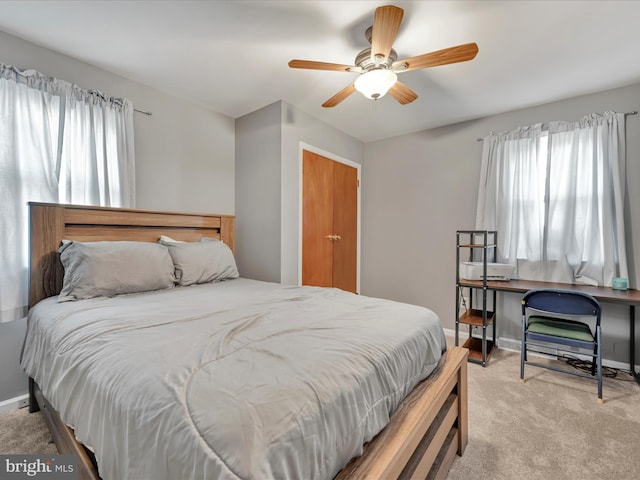 bedroom featuring ceiling fan and light carpet