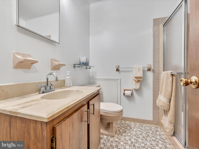 bathroom featuring tile patterned flooring, vanity, toilet, and a shower with shower door