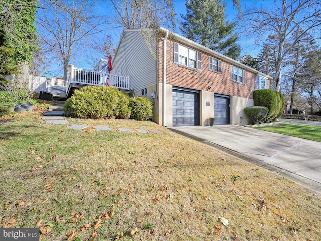 view of side of home with a wooden deck, a yard, and a garage