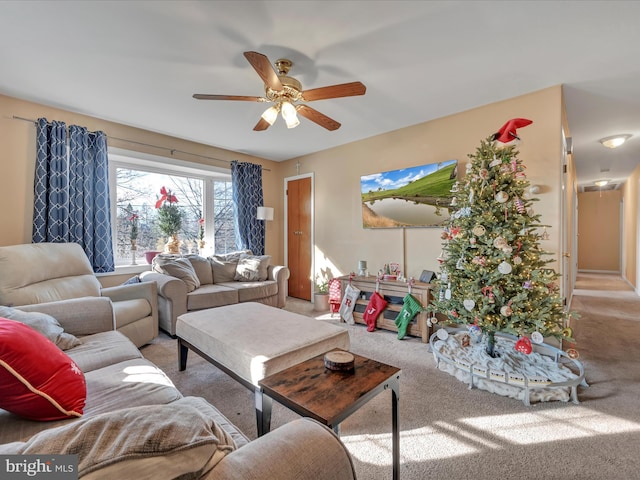 carpeted living room with ceiling fan