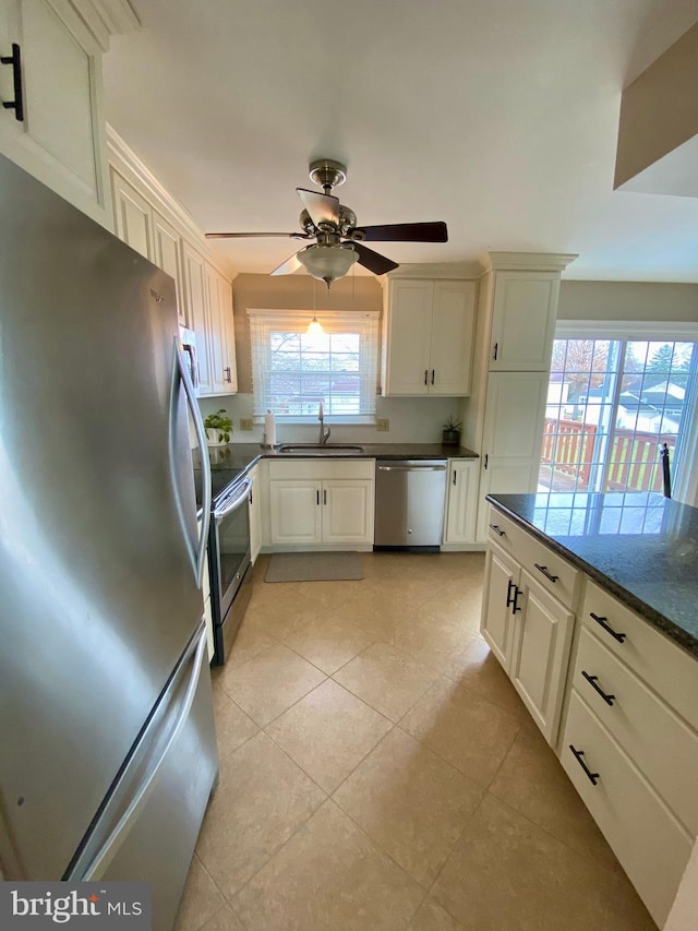 kitchen featuring white cabinetry, sink, ceiling fan, and stainless steel appliances