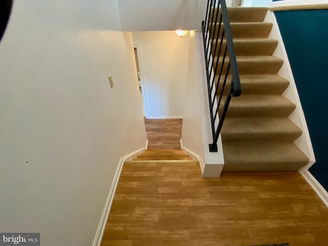 stairs with wood-type flooring