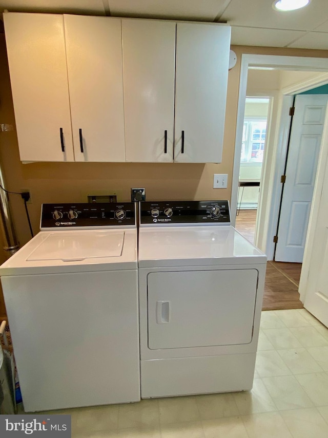 laundry area featuring cabinets and washer and clothes dryer