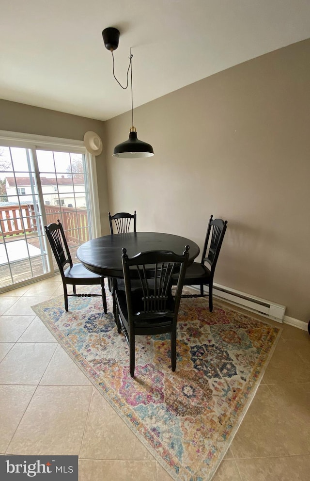 dining area with a baseboard radiator and tile patterned floors