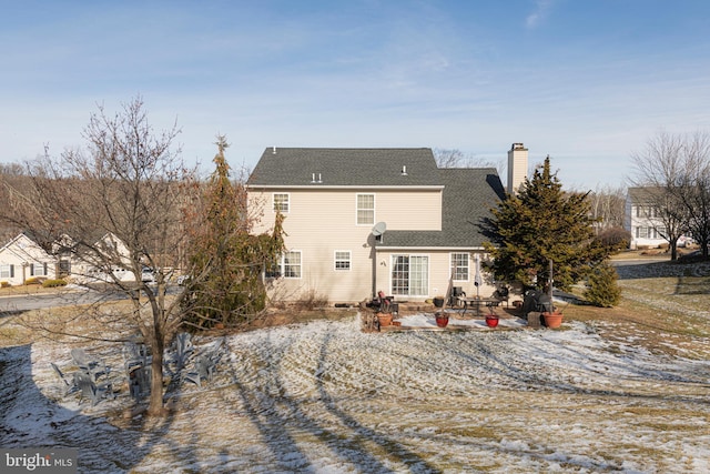 snow covered house with a patio