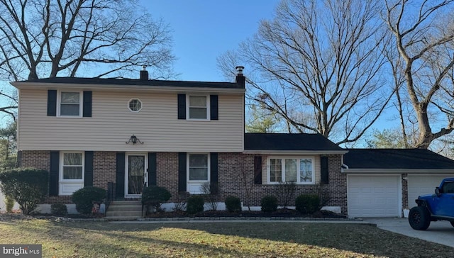 view of front of home with a front lawn and a garage