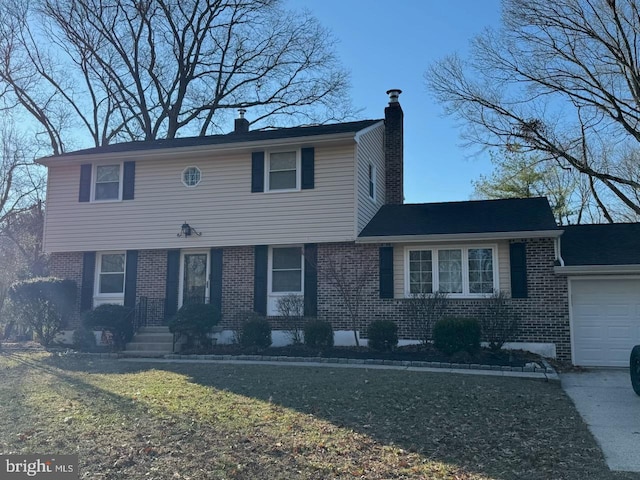 view of front of property featuring a garage and a front lawn