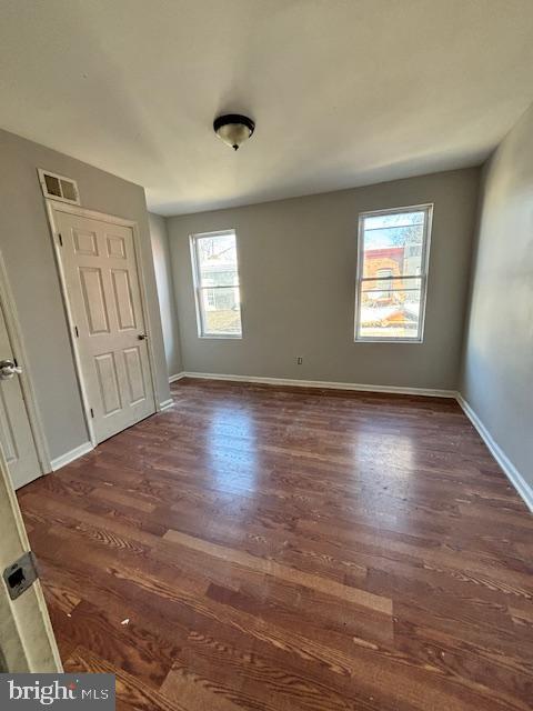 unfurnished bedroom featuring dark hardwood / wood-style flooring