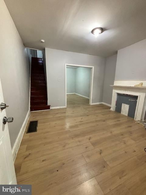 unfurnished living room with light hardwood / wood-style flooring