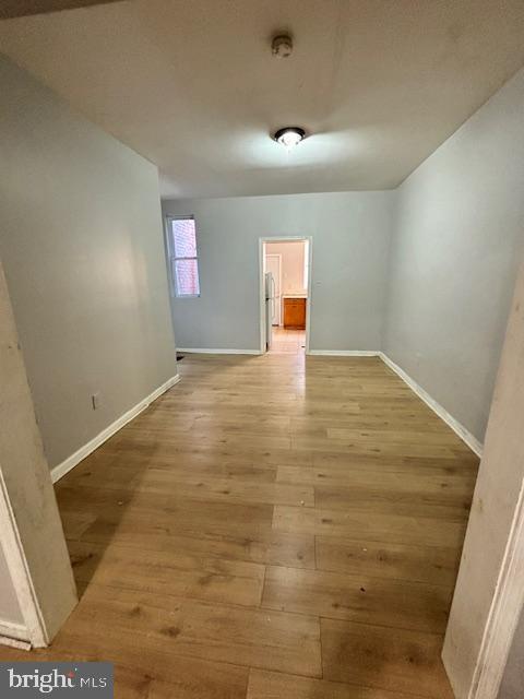 spare room featuring wood-type flooring