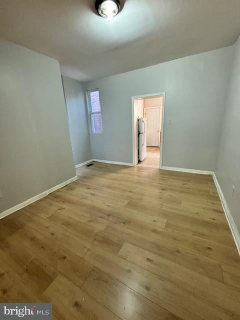 spare room with light hardwood / wood-style flooring