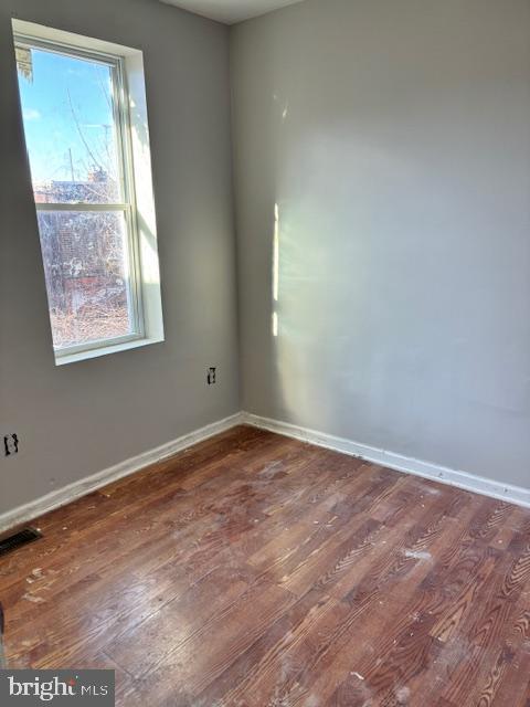 empty room featuring dark hardwood / wood-style floors