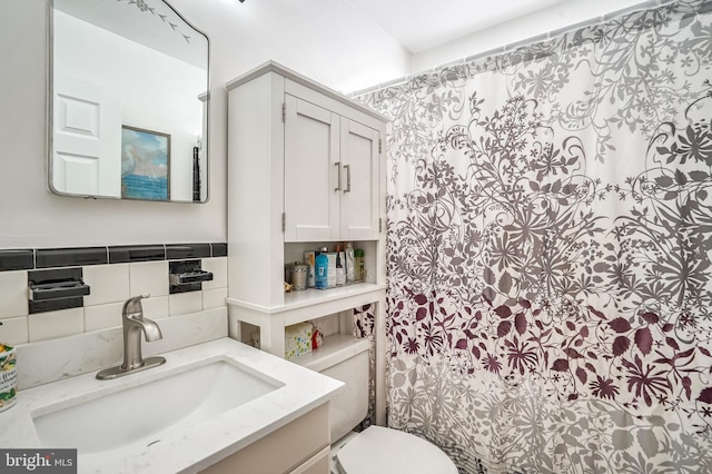 bathroom featuring vanity, toilet, and curtained shower