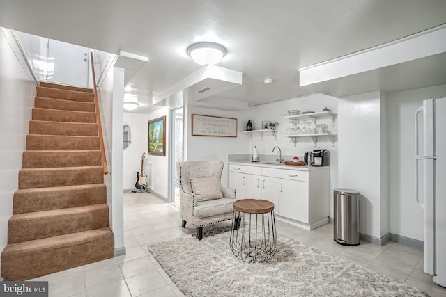 sitting room featuring wet bar and light tile patterned floors