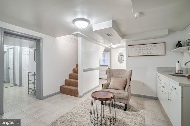 sitting room featuring light tile patterned floors and sink