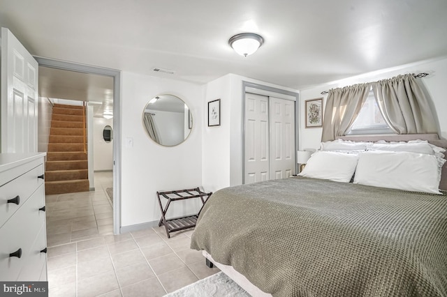 tiled bedroom with a closet