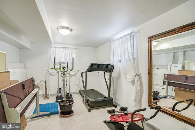 exercise area with light tile patterned floors and a wealth of natural light