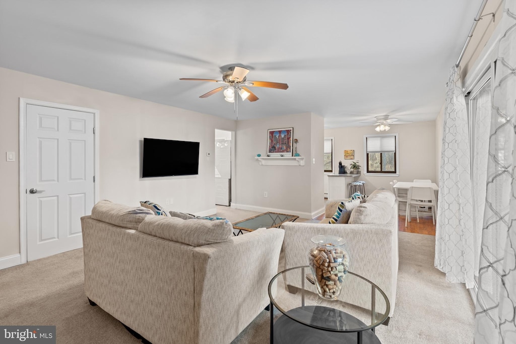 living room featuring ceiling fan and light carpet